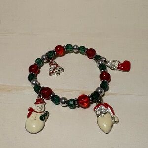 Christmas costume bracelet. With Santa, snowman, tree, and stocking.